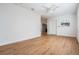 Bright living room with hardwood floors, white walls, ceiling fan and access to the front door at 3908 W Laurel St, Tampa, FL 33607