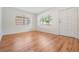 Inviting living room features hardwood floors, two windows with blinds, and a white door at 3908 W Laurel St, Tampa, FL 33607