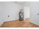 Utility room featuring a modern water heater, light walls, and wood-look laminate flooring at 3908 W Laurel St, Tampa, FL 33607