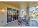 Cozy balcony features a dining table, chairs and lovely views of the area at 399 150Th Ave # 101, Madeira Beach, FL 33708