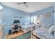 Bedroom with two twin beds, a desk, a ceiling fan, and a window at 399 150Th Ave # 101A, Madeira Beach, FL 33708