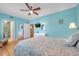 Bedroom with wood floors, ensuite bathroom, ceiling fan, and closet at 399 150Th Ave # 101, Madeira Beach, FL 33708