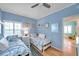 Bedroom with two twin beds, and blue walls at 399 150Th Ave # 101A, Madeira Beach, FL 33708