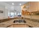 Granite countertops and stainless steel sink with updated fixtures in the kitchen at 399 150Th Ave # 101A, Madeira Beach, FL 33708