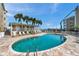 View of the pool surrounded by lounge chairs and a poolside pavilion with waterfront views at 399 150Th Ave # 101, Madeira Beach, FL 33708