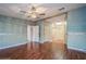 Spacious bedroom showcasing hardwood floors and multiple doorways leading to other rooms at 411 Dolphin S Dr, Oldsmar, FL 34677