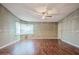 Bright and airy living room with wood flooring, decorative trim, and a modern ceiling fan at 411 Dolphin S Dr, Oldsmar, FL 34677