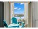 Balcony with bright blue Adirondack chairs overlooking the waterfront community at 420 64Th Ave # 402, St Pete Beach, FL 33706