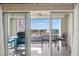 Balcony with outdoor furniture and bright blue skies, offering partial city views at 420 64Th Ave # 402, St Pete Beach, FL 33706