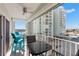 Balcony featuring outdoor seating and views of nearby buildings and the waterfront at 420 64Th Ave # 402, St Pete Beach, FL 33706