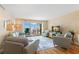 Comfortable living room featuring wood paneled walls, slider to balcony and ocean-themed decor at 420 64Th Ave # 402, St Pete Beach, FL 33706