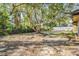 A beautiful backyard with a large tree providing shade and privacy at 421 Wayfarer Ct, Tarpon Springs, FL 34689