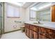 Functional bathroom with a vintage vanity, a toilet, and a bathtub-shower combo at 421 Wayfarer Ct, Tarpon Springs, FL 34689