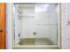 This bathroom features a shower and tub combination and glass doors at 421 Wayfarer Ct, Tarpon Springs, FL 34689