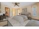 Comfortable bedroom with neutral tones, carpet flooring, a ceiling fan, and a walk in closet at 421 Wayfarer Ct, Tarpon Springs, FL 34689