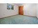 A spacious bedroom featuring blue carpeting, ample room, and a double closet with a window providing natural light at 421 Wayfarer Ct, Tarpon Springs, FL 34689