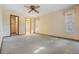 Bedroom featuring carpet flooring, two windows, and access to an ensuite bathroom at 421 Wayfarer Ct, Tarpon Springs, FL 34689