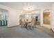 Dining area featuring modern chandelier, glass table, and mirror accent wall at 421 Wayfarer Ct, Tarpon Springs, FL 34689