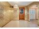 Charming entryway features tile flooring, vintage wallpaper, and a rustic wood door to complement the home's unique style at 421 Wayfarer Ct, Tarpon Springs, FL 34689