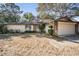 A single-Gathering home featuring a two-car garage and a cozy front yard with an inviting walkway, adorned by an American flag at 421 Wayfarer Ct, Tarpon Springs, FL 34689