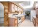 Kitchen view with vintage cabinets and appliances looking towards adjacent living space at 421 Wayfarer Ct, Tarpon Springs, FL 34689