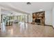 Spacious living room with tiled floors, large windows, and a stone fireplace feature at 421 Wayfarer Ct, Tarpon Springs, FL 34689