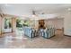 Bright and open living room with a tile floor, large windows, and a fireplace at 421 Wayfarer Ct, Tarpon Springs, FL 34689