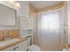 Cozy bathroom featuring a shower, sink vanity, and a toilet with overhead cabinet at 4435 34Th N Ave, St Petersburg, FL 33713