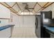 Well-lit kitchen with black refrigerator, ceiling fan, and tiled floor, offering a practical cooking space at 4435 34Th N Ave, St Petersburg, FL 33713