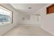 Spacious living room with carpeted floors, white walls, built-in shelving, and tile entryway at 4435 34Th N Ave, St Petersburg, FL 33713