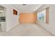 Open living space with a view into the kitchen, carpeted floors, and a large window for natural light at 4435 34Th N Ave, St Petersburg, FL 33713