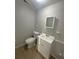 Bathroom with a white vanity, mirror, and toilet in a neutral color scheme at 4790 81St N Ave, Pinellas Park, FL 33781