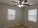 Bedroom with tile flooring, a ceiling fan, and two windows with blinds at 4790 81St N Ave, Pinellas Park, FL 33781