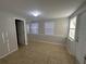 Neutral bedroom featuring tiled floors and natural light from multiple windows at 4790 81St N Ave, Pinellas Park, FL 33781