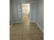 Hallway with tile flooring leading to a bedroom, decorated with a 'HOME' sign at 4790 81St N Ave, Pinellas Park, FL 33781