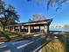 Covered lakeside pavilion with picnic tables, perfect for outdoor gatherings at 4790 81St N Ave, Pinellas Park, FL 33781