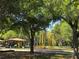 Inviting playground featuring colorful play structures and a shaded picnic area under mature trees at 4790 81St N Ave, Pinellas Park, FL 33781