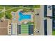 Aerial view of a community pool and shuffleboard courts with parking and green space at 4812 Jasper Dr Dr # 101, New Port Richey, FL 34652