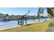 Picturesque waterfront with a gazebo, green lawn, and boats docked along the canal under a clear sky at 4812 Jasper Dr Dr # 101, New Port Richey, FL 34652