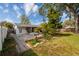 Expansive backyard featuring a charming screened-in porch and beautiful landscaping at 4837 97Th N Way, St Petersburg, FL 33708