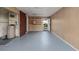 Basement area with wood-paneled walls, concrete floors, and convenient built-in shelving at 4837 97Th N Way, St Petersburg, FL 33708