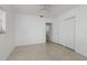 Bright bedroom featuring terrazzo floors, a ceiling fan, closet, and ensuite bathroom at 4837 97Th N Way, St Petersburg, FL 33708