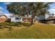 Charming red brick home with mature tree and a lush green lawn at 4837 97Th N Way, St Petersburg, FL 33708