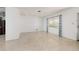 Bright living room with terrazzo floors and views through a large window at 4837 97Th N Way, St Petersburg, FL 33708