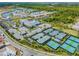 Aerial view of a community center featuring a swimming pool, tennis courts and lush landscaping at 4911 Sienna Isles Ave, Wimauma, FL 33598