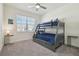 Cozy bedroom includes bunk beds with gray wood finish, side tables, and ample light at 4911 Sienna Isles Ave, Wimauma, FL 33598