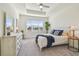 Bright bedroom with a tray ceiling, large windows, and a neutral color palette at 4911 Sienna Isles Ave, Wimauma, FL 33598