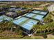 Overhead view of the community tennis and pickleball courts with beautiful landscaping at 4911 Sienna Isles Ave, Wimauma, FL 33598