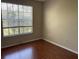 Simple bedroom with light-filled window overlooking treed neighborhood at 5125 Palm Springs Blvd # 11306, Tampa, FL 33647