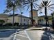 Community clubhouse featuring manicured landscaping, mature palm trees, and a convenient handicap parking spot at 5125 Palm Springs Blvd # 11306, Tampa, FL 33647